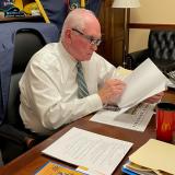 Rep. Kelly reading over the text of a bill in his Washington, D.C. office.